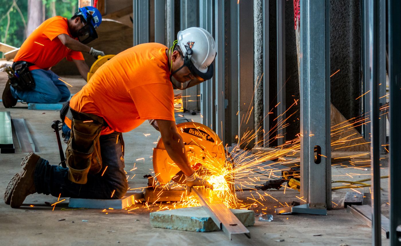 Tradespeople cutting steel framing at a jobsite in Raleigh, North Carolina